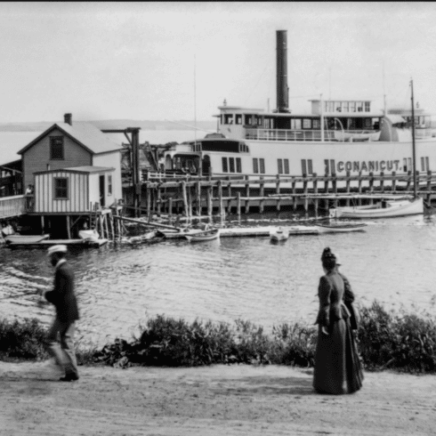 Black and white historical photo showing a steamboat named "Connecticut" docked at a pier in Newport, RI, with a man walking and a woman standing by the shoreline.