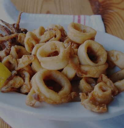 A plate of fried calamari rings served with a lemon wedge at a Newport, RI hotel.